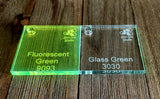 Sample squares of 1/4" cast acrylic in two colors; Fluorescent Green and Glass Green.